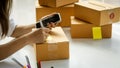 A woman`s hand holding a phone, taking her notes, and a box placed next to the idea of Ã¢â¬â¹Ã¢â¬â¹selling things online Royalty Free Stock Photo